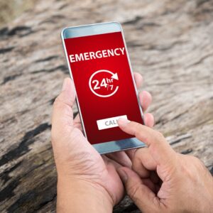person dialing emergency number