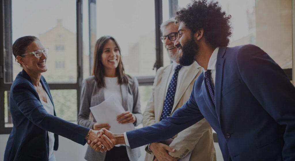 People shaking hands at a meeting