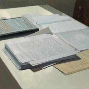 A focused, close-up shot of legal paperwork and a gavel resting on a bright wooden desk surface.